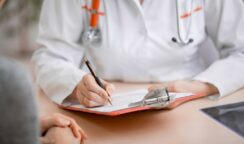 Doctor or physician writing diagnosis